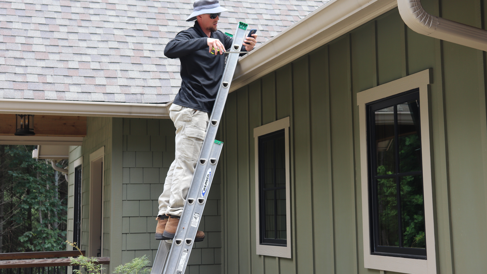 An MBA Roofing technician levels and secures a newly installed gutter and downspout, part of the warranty-backed gutter replacement we've provided North Carolina homeowners since 2007.