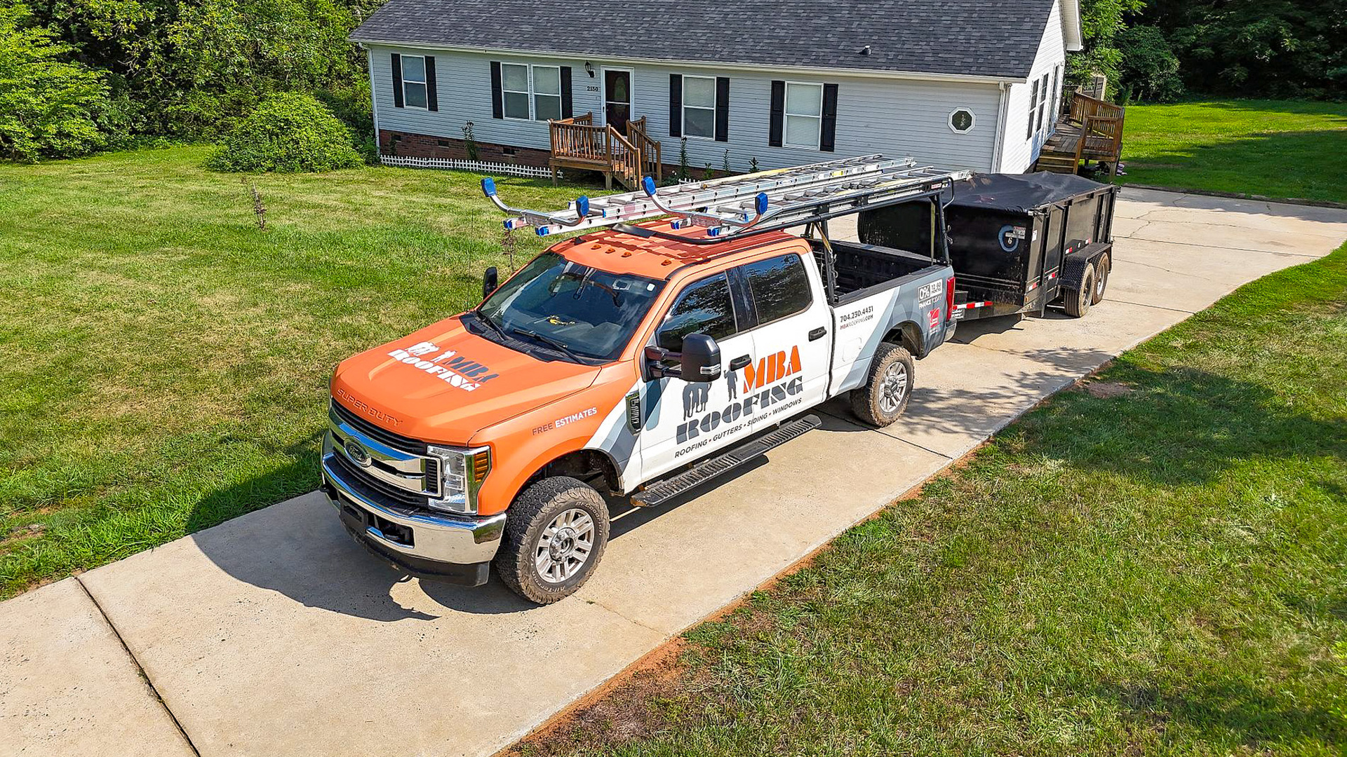 MBA Roofing truck and trailer parked at a North Carolina home
